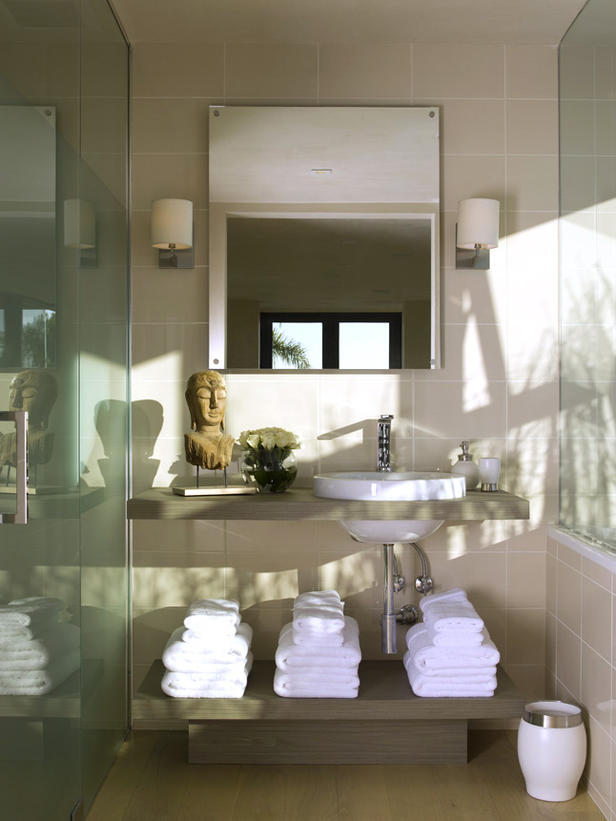 Bathroom-with-gray-eco-friendly-veneers-a-sink-and-folded-white-towels