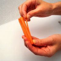 Lift out carrot wedge with tip of knife.