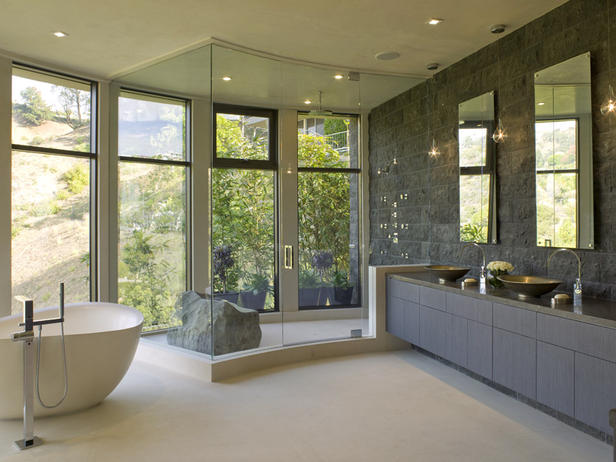 Master-bathroom-with-natural lava rock-walls-floor-to-ceiling-windows-a-steam-shower-for-two-body-jets-eco-friendly-cabinets-and-a-tub